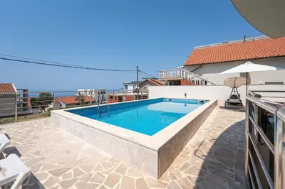 a swimming pool in the middle of a house at Four Seasons Villa Valentina in Kotor