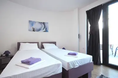 a bedroom with two beds with towels on them at Apartments Jadranski Biser in Čanj