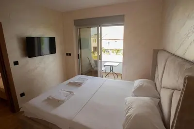 a bedroom with a bed and a tv on the wall at Amber Lux Apartments in Ulcinj