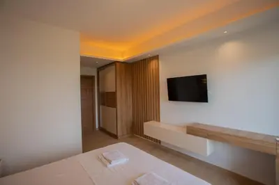a hotel room with a television on a wall at Amber Lux Apartments in Ulcinj