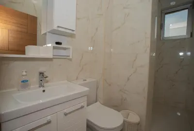 a bathroom with a sink and a toilet and a shower at Amber Lux Apartments in Ulcinj