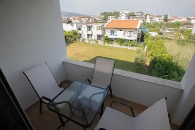 two chairs and a glass table on a balcony at Amber Lux Apartments in Ulcinj