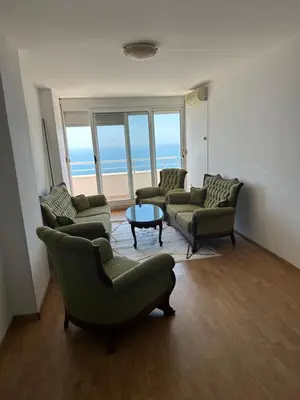 a living room with three couches and a table at Apartment Miricle by the sea 2 in Ulcinj