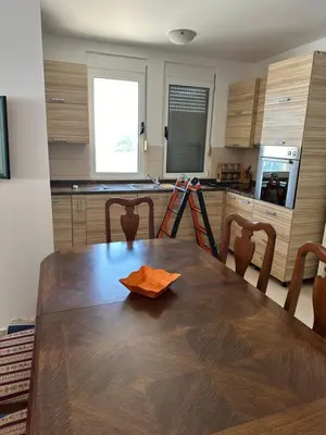 a kitchen with a wooden table in a kitchen at Apartment Miricle by the sea 2 in Ulcinj