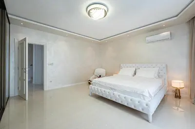 a bedroom with a white bed with a stuffed animal at Luxury Villa Boričić in Kotor