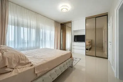 a bedroom with a large bed and a television at Luxury Villa Boričić in Kotor