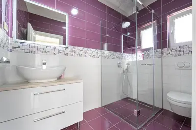 a bathroom with a sink and a shower with purple tiles at Luxury Villa Boričić in Kotor