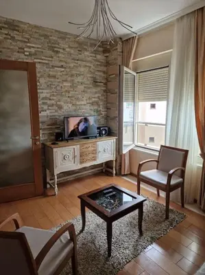 a living room with a tv and a table and chairs at P&N Bu2 in Budva