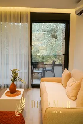 a living room with a couch and a sliding glass door at OleaMar in Bar