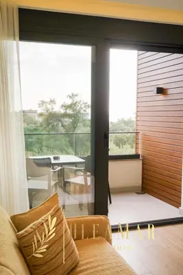 a living room with a couch and a large glass door at OleaMar in Bar