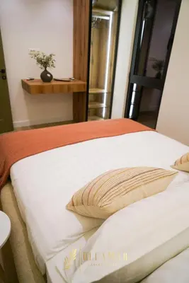 a bed with a pillow on top of it at OleaMar in Bar