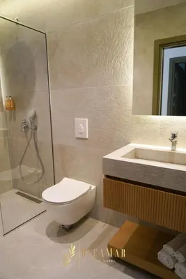 a bathroom with a shower and a toilet and a sink at OleaMar in Bar