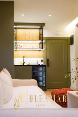 a bedroom with two beds and a green door at OleaMar in Bar