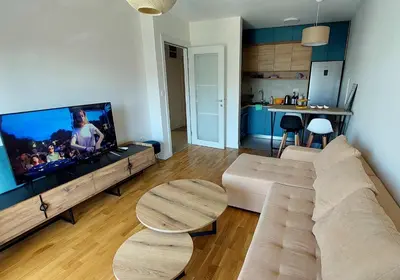 a living room with a couch and a flat screen tv at Urban Escape Apartment in Pobrežje