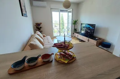 a living room with a table with shoes on it at Urban Escape Apartment in Pobrežje