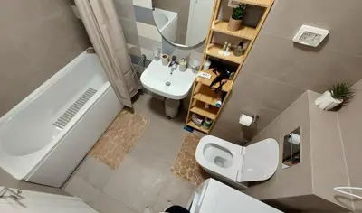 an overhead view of a bathroom with a toilet and a sink at Urban Escape Apartment in Pobrežje