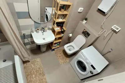 a bathroom with a sink and a toilet and a mirror at Urban Escape Apartment in Pobrežje