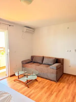 a living room with a couch and a glass table at Velic in Ulcinj
