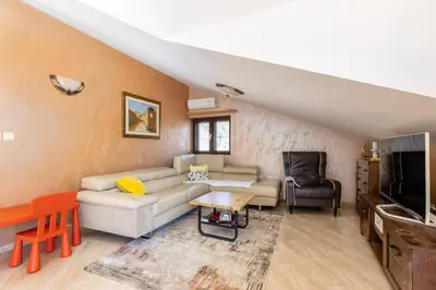 a living room with a couch and a tv at LuSi SeaView Apartment in Kotor