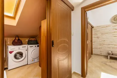a laundry room with a washer and dryer at LuSi SeaView Apartment in Kotor