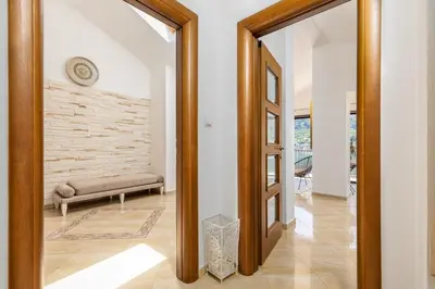 a hallway with a mirror in a house at LuSi SeaView Apartment in Kotor