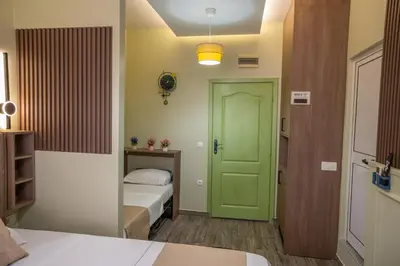 a room with a green door and a bed at Hana Apartments in Ulcinj