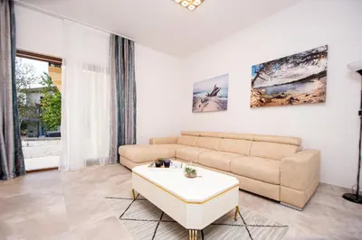 a living room with a couch and a table at Stone Villa with pool Montenegro Star in Kaluđerac