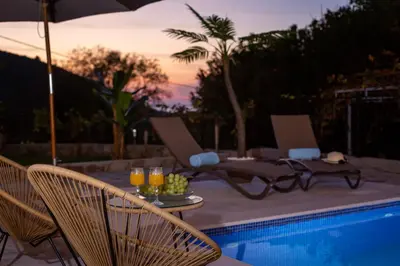 a patio with a table and chairs and a pool at Stone Villa with pool Montenegro Star in Kaluđerac