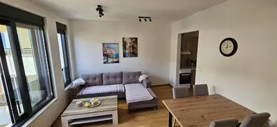 a living room with a couch and a table at New apartment beach 240m Becici in Becici