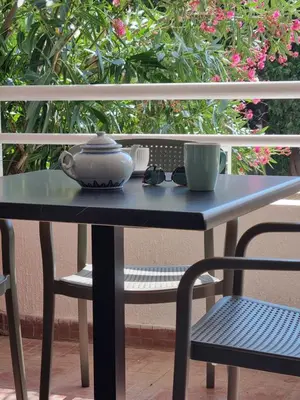 a blue table and chair with a tea pot and a cup at Petrovac modern apartment in Petrovac na Moru