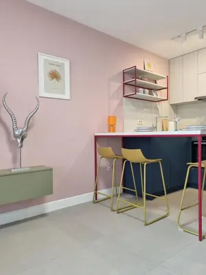 a kitchen with a blue counter and yellow stools at Petrovac modern apartment in Petrovac na Moru