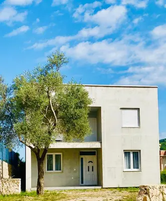 a white house with a tree in front of it at BonacaL&I in Bar