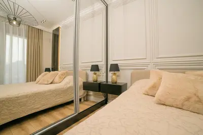 a bedroom with two beds and a mirror at Luxury Apartment with Green Terrace, Porto Milena View and Private Garage in Ulcinj