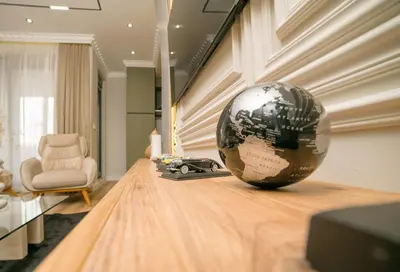 a large globe sitting on a table in a room at Luxury Apartment with Green Terrace, Porto Milena View and Private Garage in Ulcinj