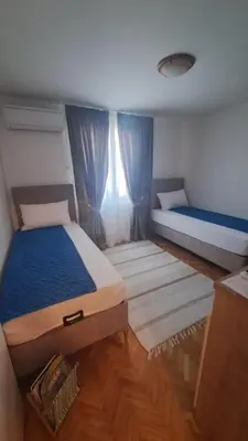 a small bedroom with two beds and a window at Odore di Bar in Bar
