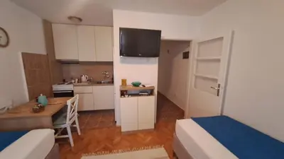 a small room with two beds and a kitchen at Odore di Bar in Bar