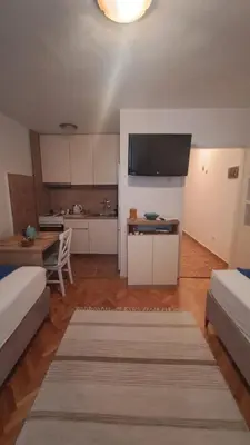 a living room with two beds and a kitchen at Odore di Bar in Bar