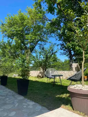 a park with two chairs and a table and trees at Oasis of peace in Budva