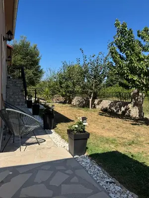 a bench sitting on a porch next to a yard at Oasis of peace in Budva