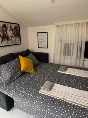 a bedroom with a large bed with yellow pillows at Oasis of peace in Budva