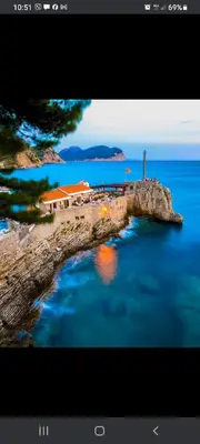 an island in the water with a house on it at Apartman Manja Petrovac in Petrovac na Moru
