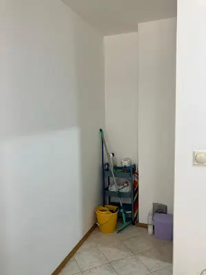 a room with a white wall and a yellow bucket at PePa in Petrovac na Moru