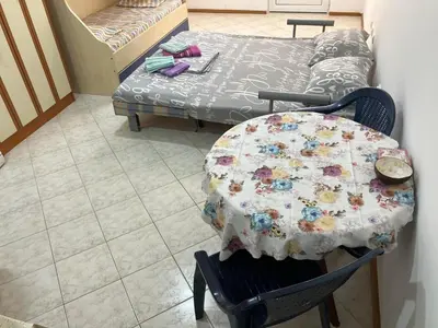 a table and chair with a table and a couch at PePa in Petrovac na Moru