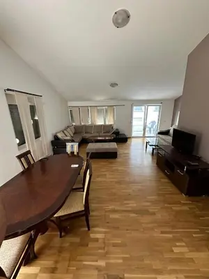 a large living room with a table and a couch at Stellax Apartment in Donji Štoj