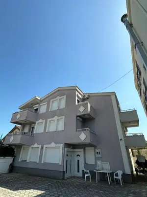 a building with two chairs in front of it at Stellax Apartment in Donji Štoj