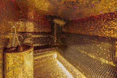 a room full of gold tiled walls and ceilings at Hotel Tre Canne in Budva