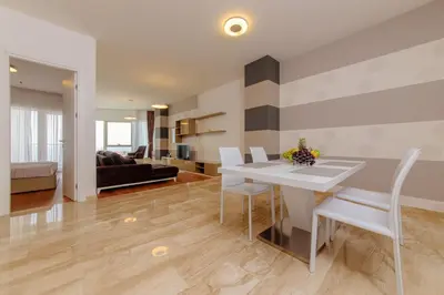 a kitchen and living room with a table and chairs at Hotel Tre Canne in Budva