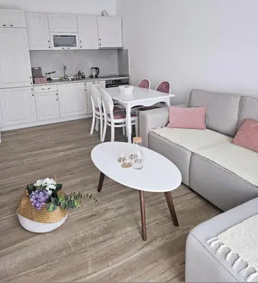 a living room with two tables and a couch at SOL Apartment in Ulcinj
