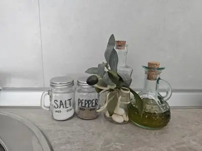 a counter with jars and a vase with a plant in it at SOL Apartment in Ulcinj