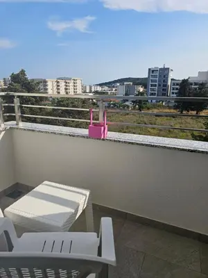 a balcony with a table and a chair on a roof at SOL Apartment in Ulcinj